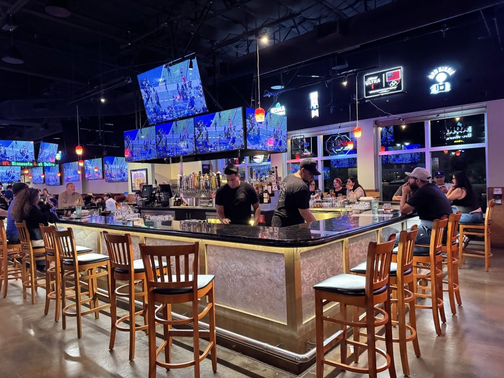 Burgers and Beer sports bar with multiple televisions surrounding the main bar
