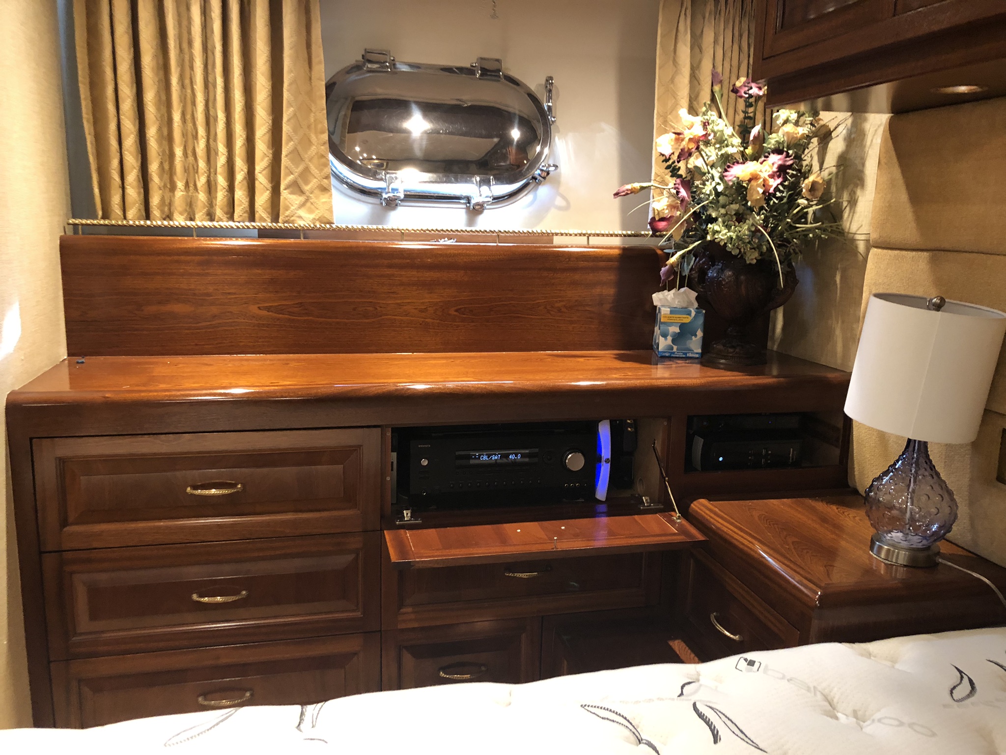 Yacht AV equipment integrated into stateroom cabinetry